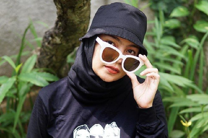 Pakai kacamata hitam atau topi wisata